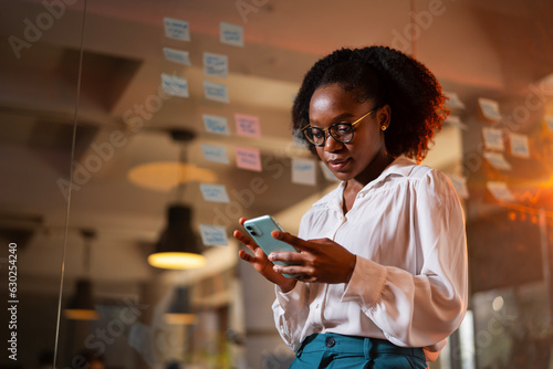 Happy businesswoman in office. Portrait of beautiful businesswoman using the phone.