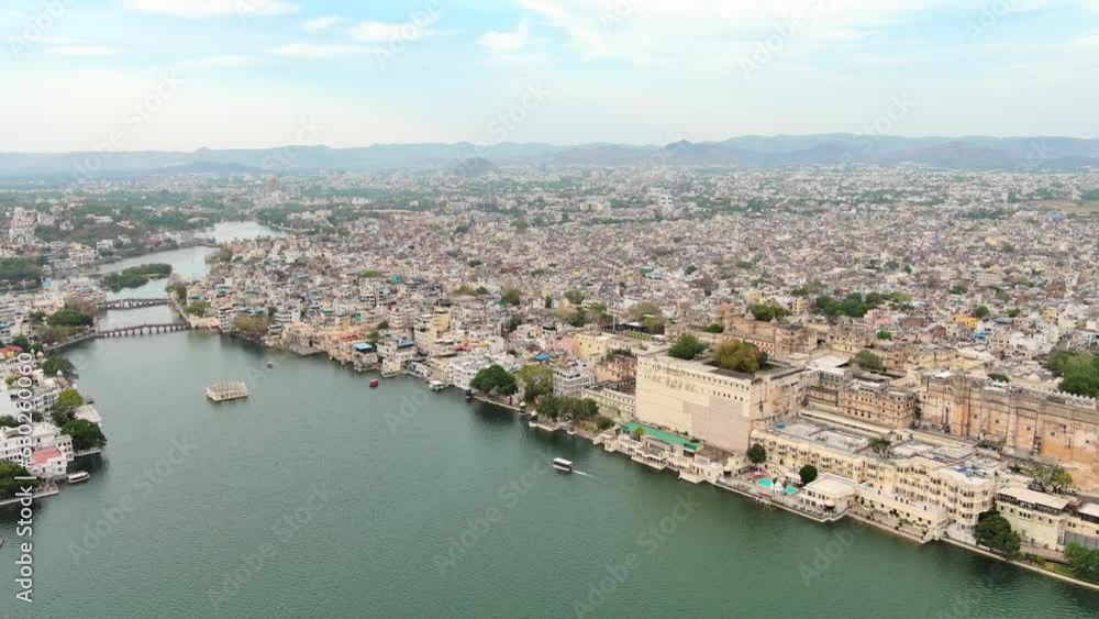 Udaipur, India: Aerial view of city in Rajasthan, famous City Palace of Udaipur and Lake Pichola - landscape panorama of South Asia from above Udaipur, India: Aerial view of city in Rajasthan, famous City Palace of Udaipur and Lake Pichola - landscape panorama of South Asia from above