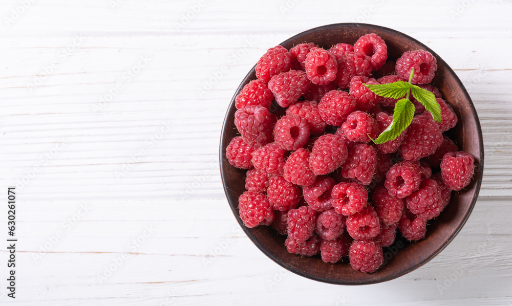 Raspberry in a basket .on wooden background Raspberry in a basket .on wooden background