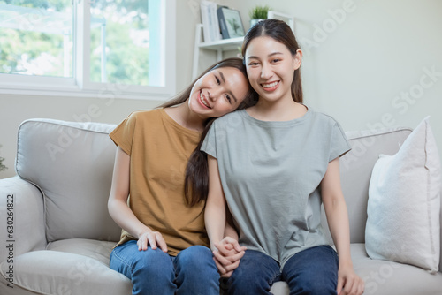 Happy lesbian girlfriends sitting holding hands. Asian girl couple. young woman relationship. LGBTQ lover lesbian.