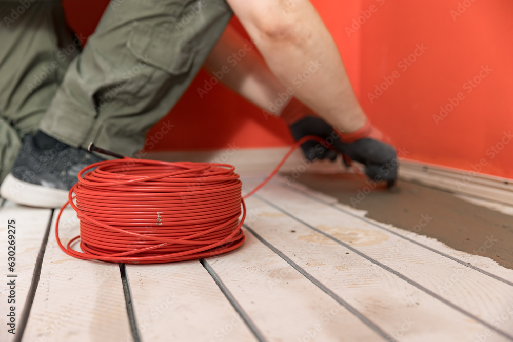 Process master install underfloor heating electrical cable Stock Photo