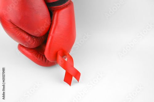 Red ribbon with boxing gloves, wrestling symbol.