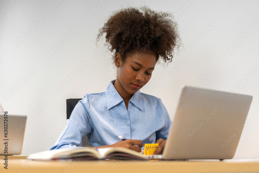 Young black african woman relaxing using laptop computer working and startup idea at office.Young creative african woman working and typing on keyboard smart online at company Young black african woman relaxing using laptop computer working and startup idea at office.Young creative african woman working and typing on keyboard smart online at company