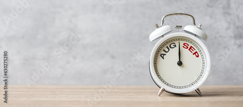 Hello September  Changed from August month with vintage alarm clock on table background. Calendar, Monthly, New Start, Resolution, Goals, Plan, Action and Mission Concept