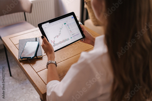 First person view of female hold digital tablet in cafe. Table with cup of coffee