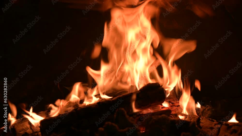 Burning fire in the fireplace in old rural house. Logs burning in the heater Burning fire in the fireplace in old rural house. Logs burning in the heater