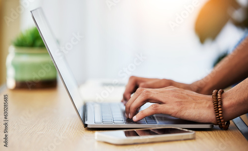 Closeup, work from home and hands with a laptop, typing and connection with network, smartphone and keyboard. Person, entrepreneur or freelancer with pc, deadline and search internet for website info