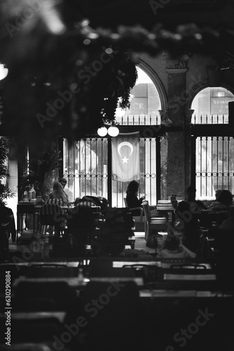 Istanbul, Turkey - 23 April 2023: View of people dining in a restaurant in Beyoglu district of Istanbul, Turkey. photo