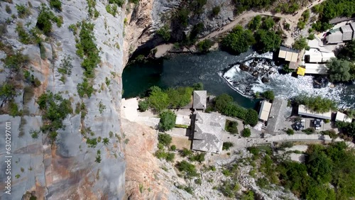 Aerial drone view of Tekija in Blagaj and source of Buna river. Tekke is historical dervish house. Cliffs above tekke in Bosnia and Herzegovina. photo