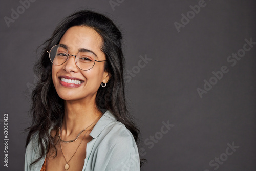 Portrait of cheerful hispanic woman with eyeglasses smiling