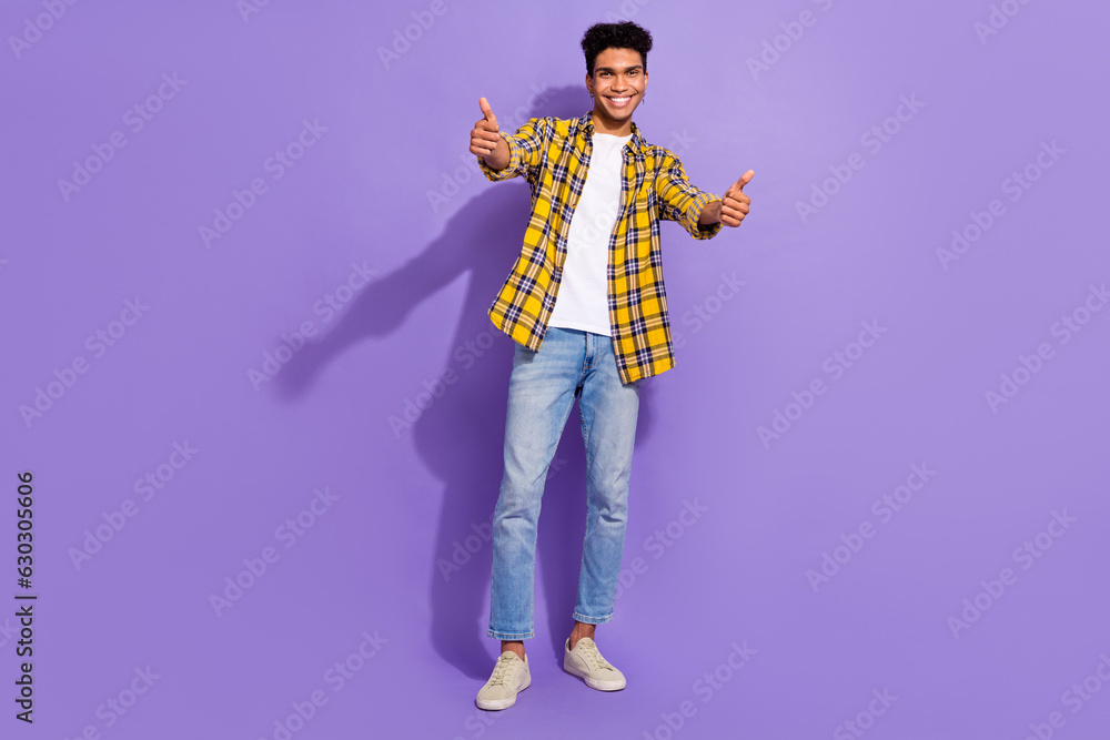 Full size photo of cheerful young man arms fingers demonstrate thumb up approval isolated on violet color background