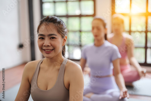 Asian women exercising in yoga fitness studio. © Somkiat