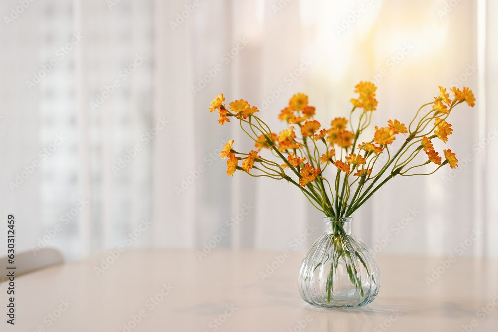 Yellow bouquets in clear glasses on wooden table with white curtains background in a coffee shop. Yellow bouquets in clear glasses on wooden table with white curtains background in a coffee shop.