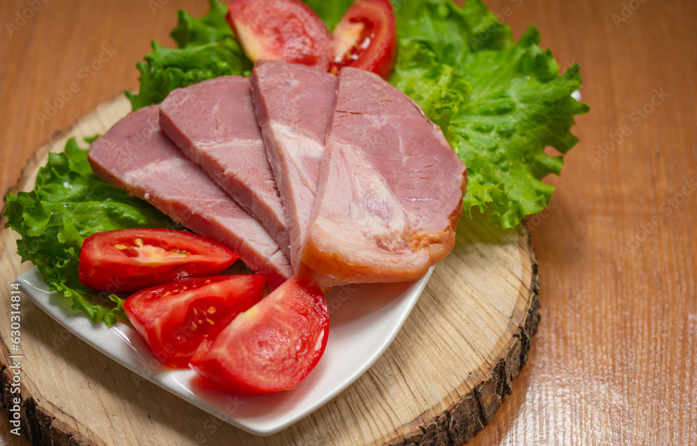 meat with herbs and tomato slices on a platter meat with herbs and tomato slices on a platter
