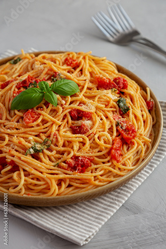 Homemade Spaghetti With Fresh Tomato Sauce on a Plate, side view.