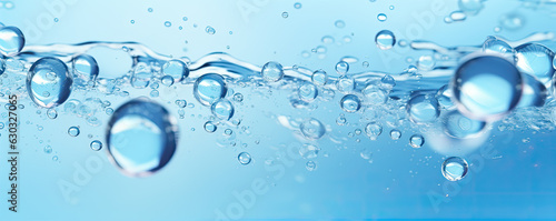 Water drops or oil bubbles on blue background. Droplets panorama picture.