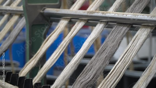 Linen production. Production process. Material processing plant. Creation of yarns and ropes. Industrial plant. A workshop with working machines. Close-up of production.