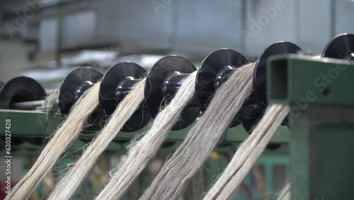 Linen production. Production process. Material processing plant. Creation of yarns and ropes. Industrial plant. A workshop with working machines. Close-up of production.