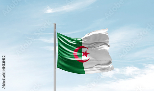Algeria national flag waving in sky.