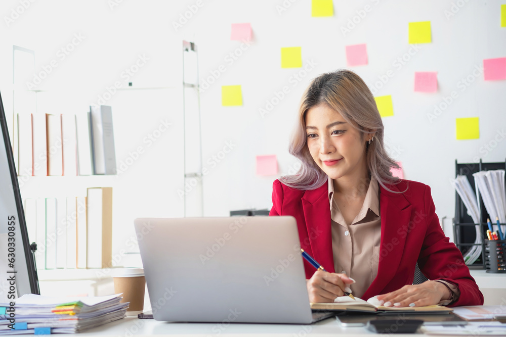 Beautiful young teen asian businesswoman using note pad thinking with planning working on financial document, tax, exchange, accounting and Financial advisor. Beautiful young teen asian businesswoman using note pad thinking with planning working on financial document, tax, exchange, accounting and Financial advisor.