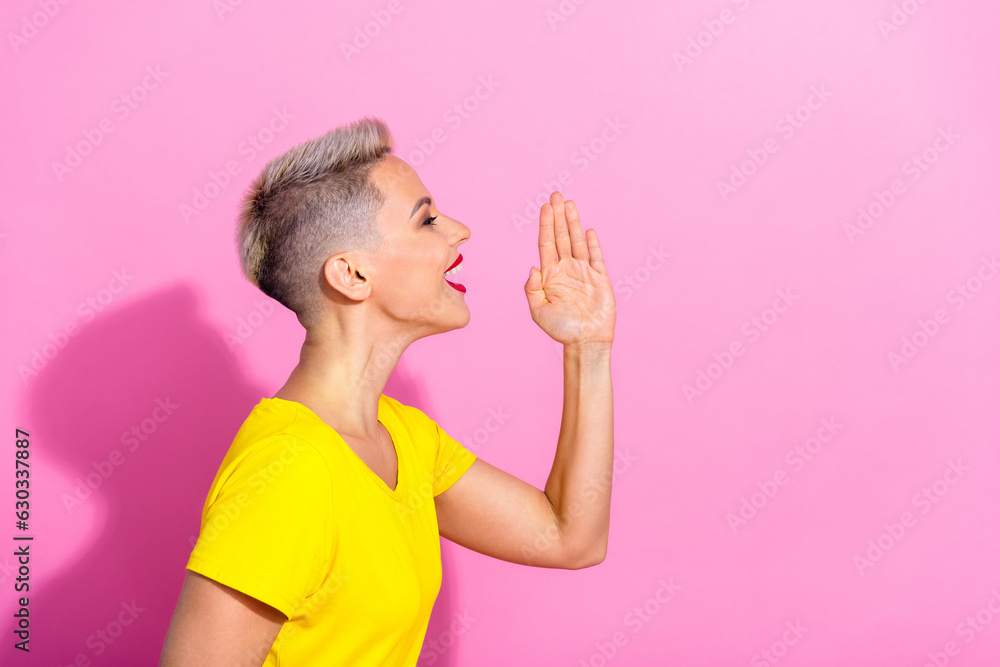 Profile photo of funky positive girl hand near mouth communicate talk empty space isolated on pink color background Profile photo of funky positive girl hand near mouth communicate talk empty space isolated on pink color background