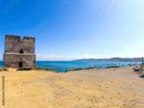 View of the historic landmark Torre del Salto de la Mora and the beautiful coastline on the blue Mediterranean Sea on the Andalusian Coast, Bahía de Casares, Estepona, Andalusia, Malaga, Spain
