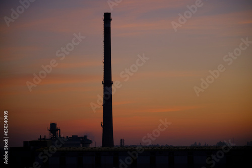 Industrial pipe on the background of beautiful sunset. Evening time