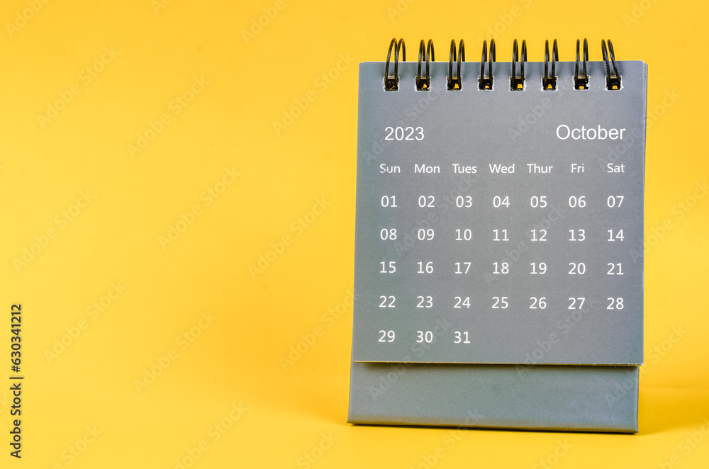 The October 2023 Monthly desk calendar for 2023 year on yellow background. - obrazy, fototapety, plakaty 
