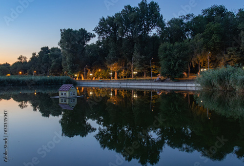 Beautiful reflection on a lake in a public park in Chisinau at sunset