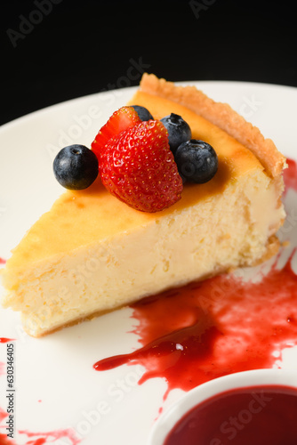 Appetizing dessert cheesecake on a white plate.