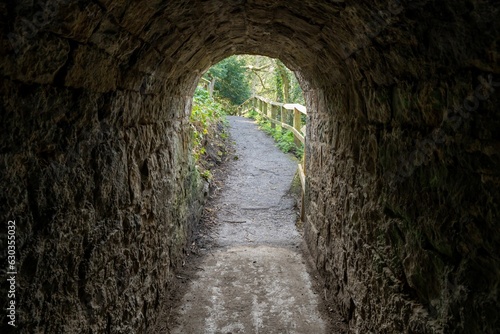 A view through an old quarrying tunnel, now a footpath in Jesmond Dene, Newcastle upon Tyne, UK photo