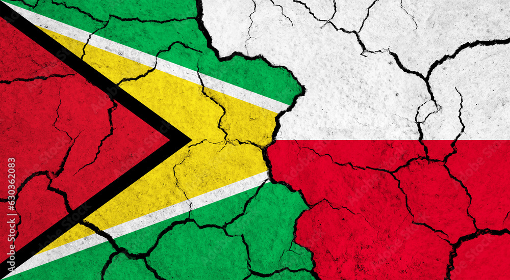 Flags of Guyana and Poland on cracked surface - politics, relationship concept