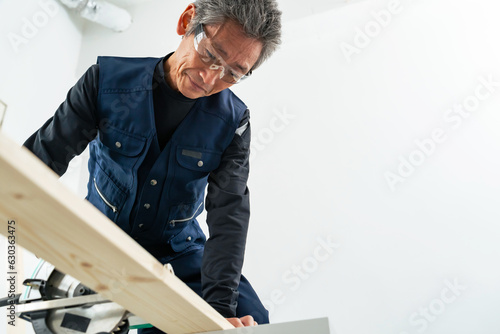 丸ノコで木材をカットする男性　大工　DIY photo