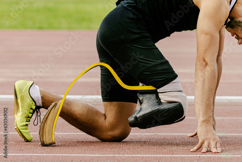 athlete disability runner starting position in running sprint race, sports summer games photo