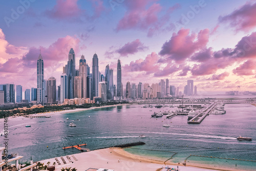 City of skyscrapers, Dubai marina in the sunny day with front line of beach hotels and blue water of Persian gulf. Dubai, UAE United Arabs Emirates.