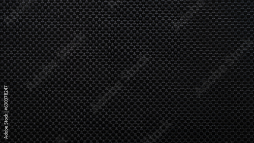 Black faux textured leather material background closeup concept