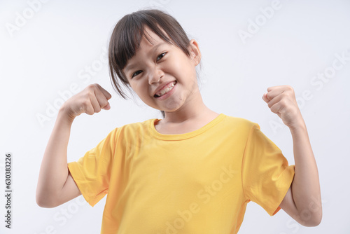 strong youngster showing muscles and biceps, isolated on white background