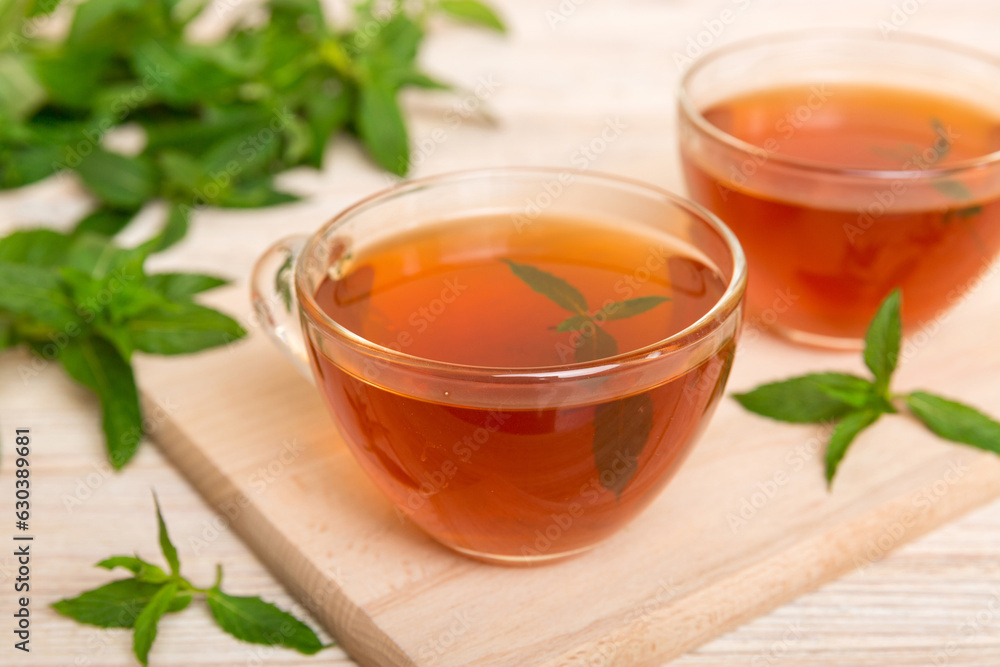 Cup of mint tea on table background. Green tea with fresh mint top view with copy space Cup of mint tea on table background. Green tea with fresh mint top view with copy space