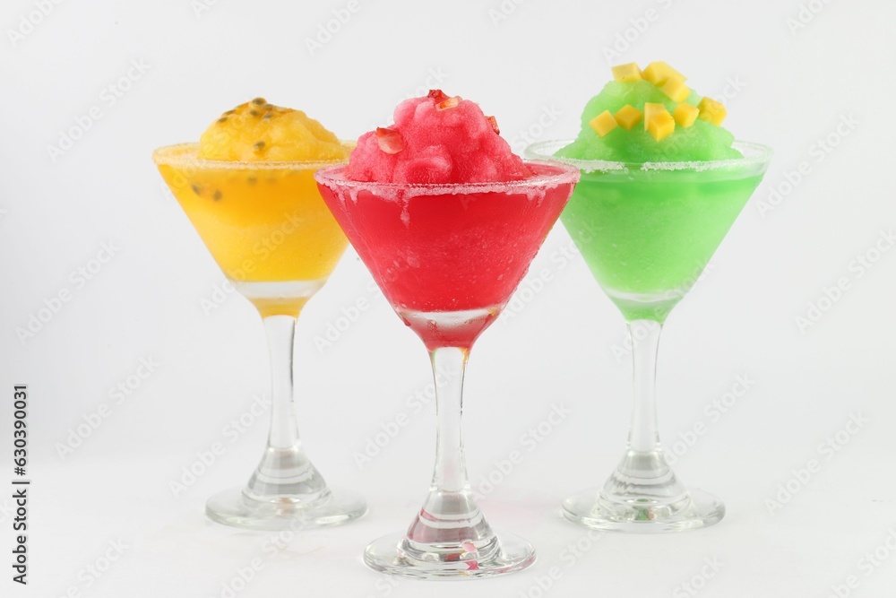 Delightful martini glasses filled with different colored cocktails, all frosted with condensation