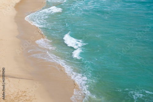 Aerial shot of a sandy beach and ocean shoreline. photo