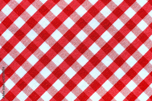 The texture of linen fabric in a large cell of red and white. Scottish tailoring material. checkered fabric