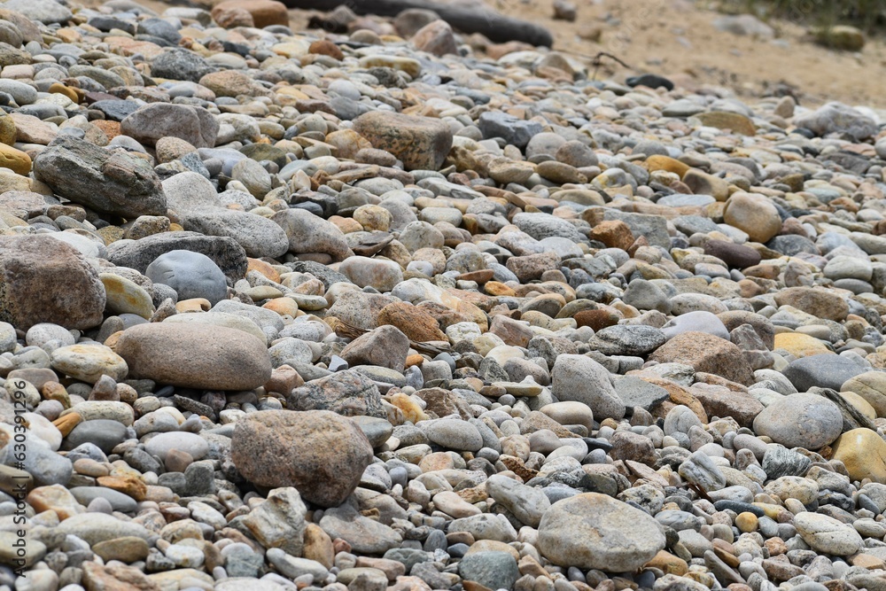 Array of stones and pebbles in a tranquil beach setting Array of stones and pebbles in a tranquil beach setting