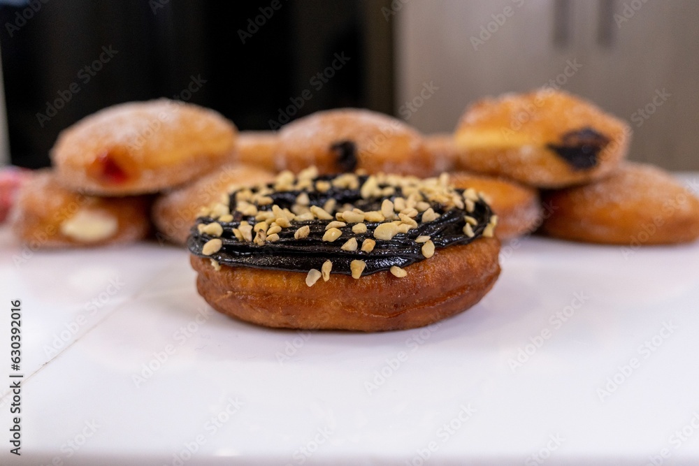 several donuts on a counter top with chocolate frosting