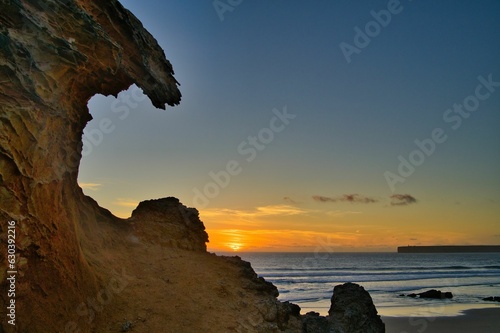 Scenic view of the coastal cliffs and tranquil ocean at sunset. Portugal, Sagres, Atlantic coast.