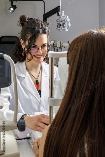 Female doctor conducting an ophthalmological examination on a female patient.
