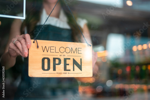 Woman entrepreneur with Open sign in cafe shop , small business concept