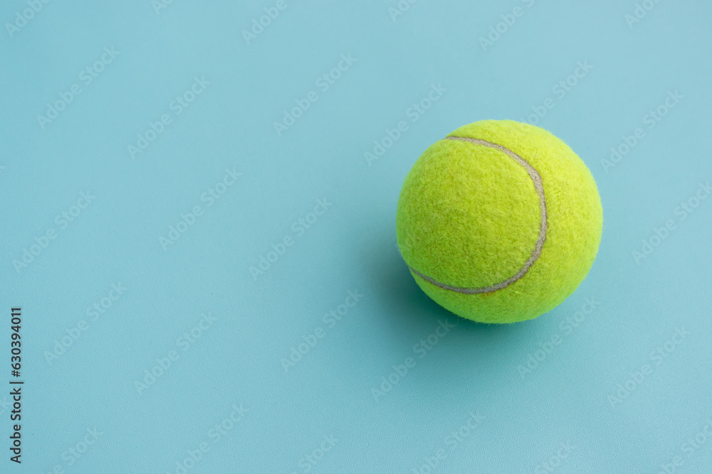 A tennis ball isolated on blue background, after some edits.