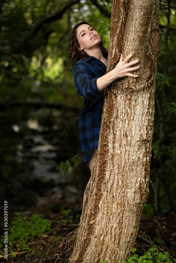 Young Caucasian woman posing with a tree in the Kirstenbosch National Botanical Garden in Cape Town. Young Caucasian woman posing with a tree in the Kirstenbosch National Botanical Garden in Cape Town.