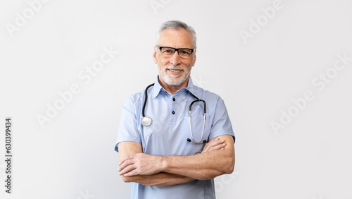 smiling mature doctor standing with crossed arms