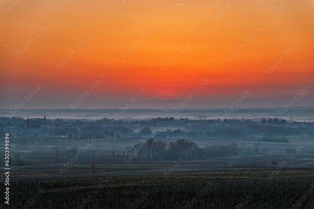 Sunset over the farmland in the mist